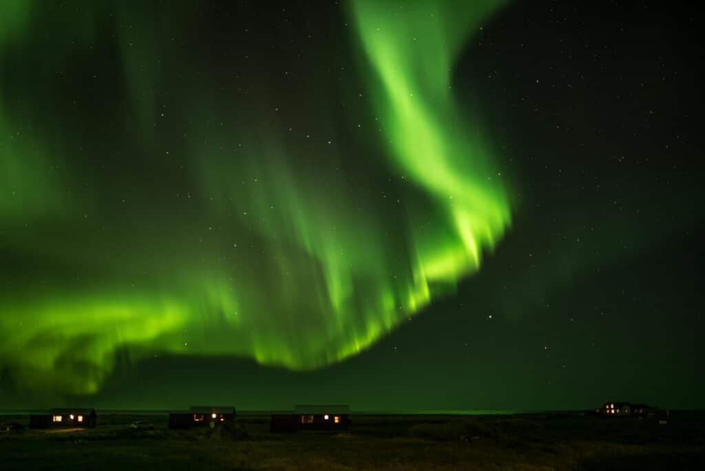 Stunning aurora borealis illuminating the night sky over Grindavík, Iceland.