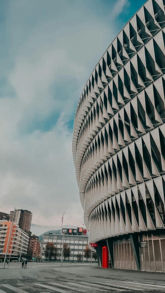 View of the San Mamés Stadium's modern facade and surrounding urban area in Bilbao, Spain.